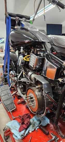 A motorcycle is being worked on in a garage.