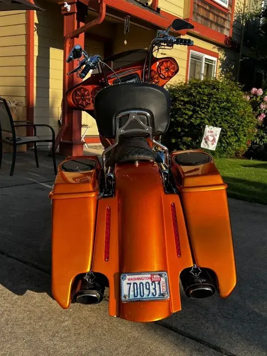 A motorcycle with a license plate that says 700931 is parked in front of a house.