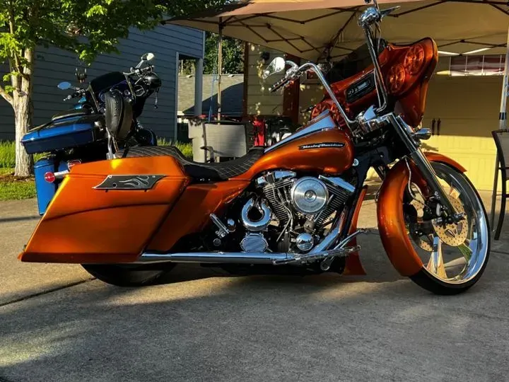 Two harley davidson motorcycles are parked next to each other in a driveway.