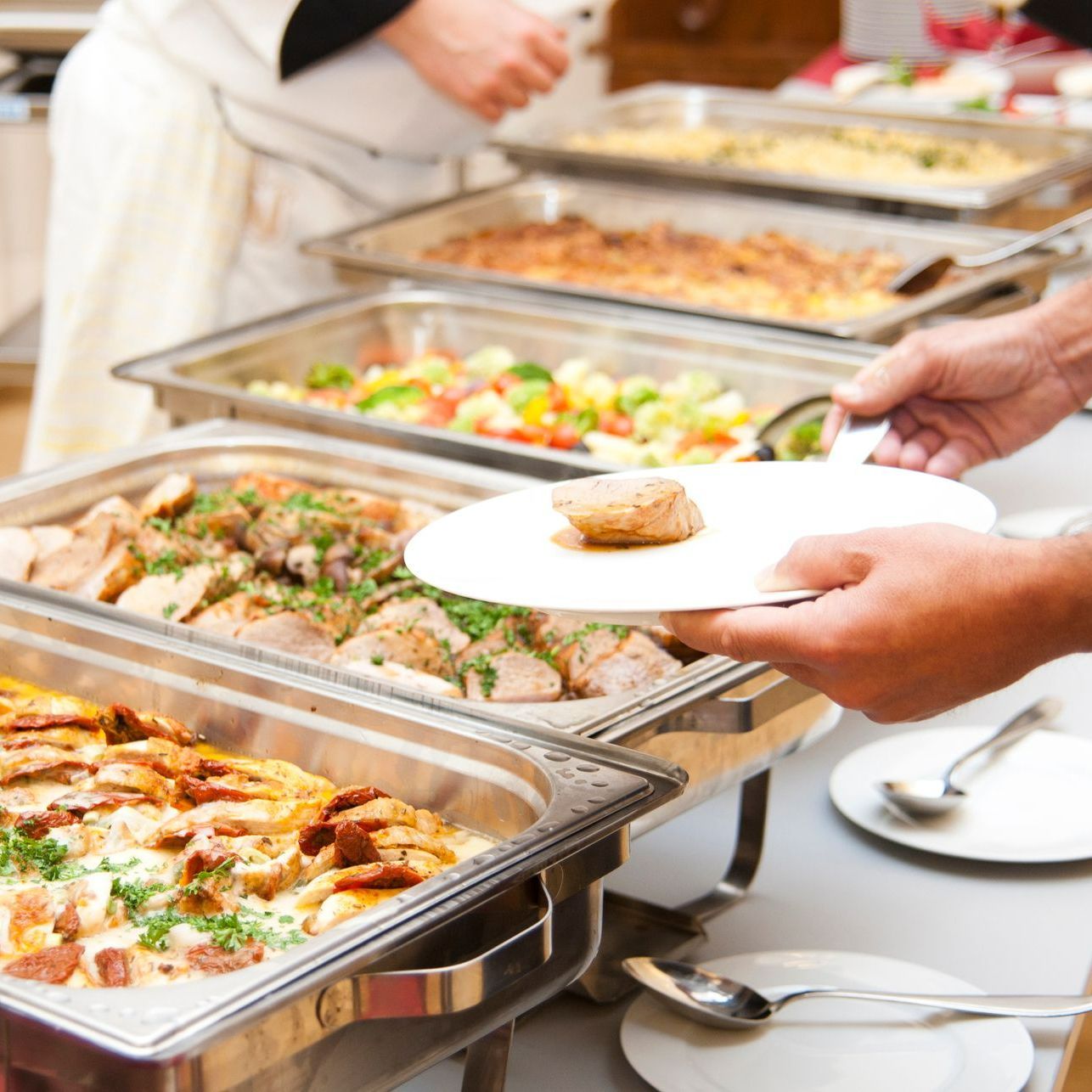 A Person Is Taking A Plate Of Food From A Food Catering - Henrico, VA - Napoli Pizza A Person Is Taking A Plate Of Food From A Food Catering - Henrico, VA - Napoli Pizza