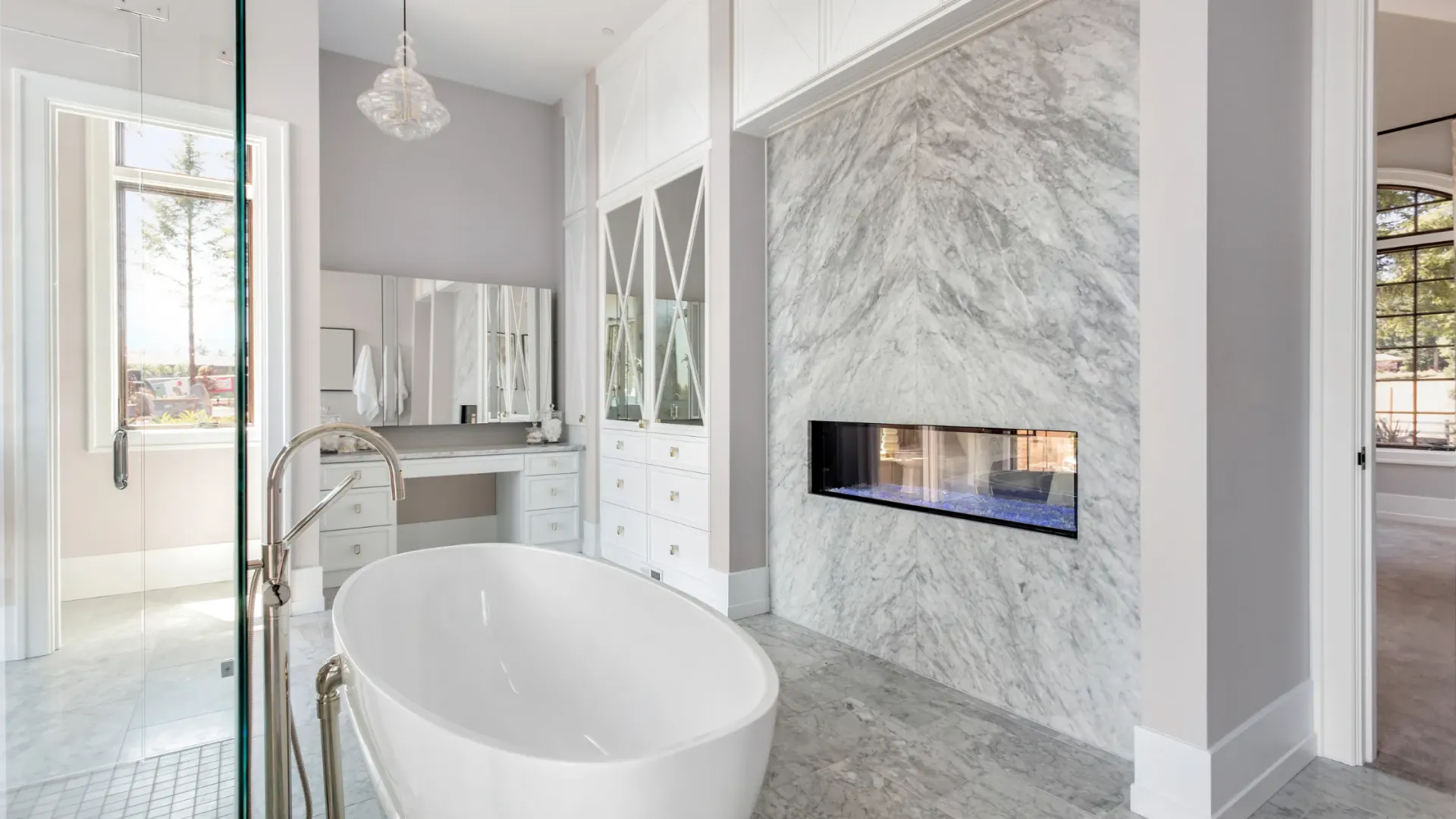 A bathroom with a tub and a fireplace in the wall.