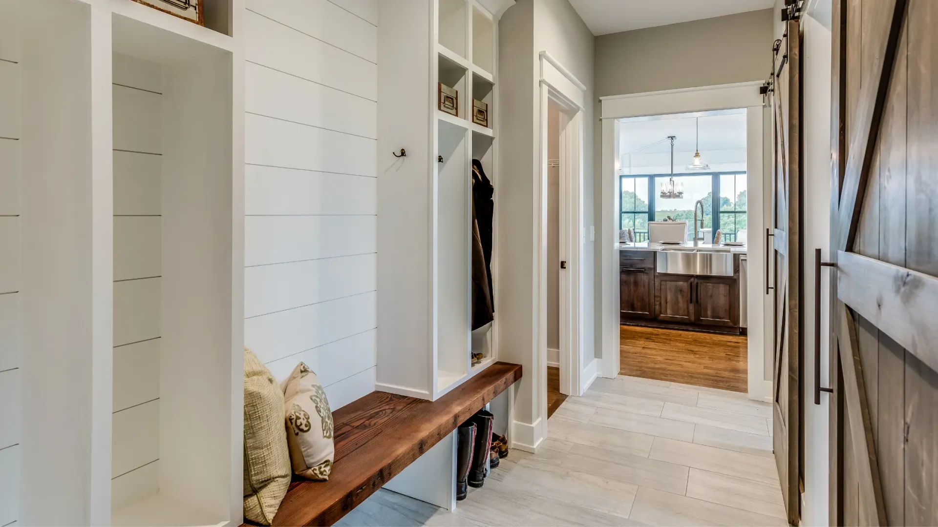 A walk in pantry with lots of shelves and a door.