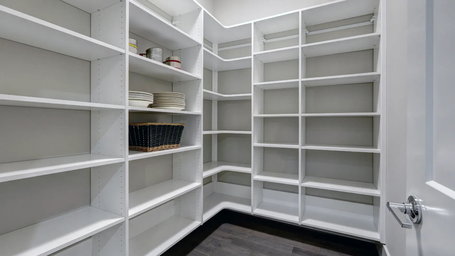 A walk in pantry with lots of shelves and a door.