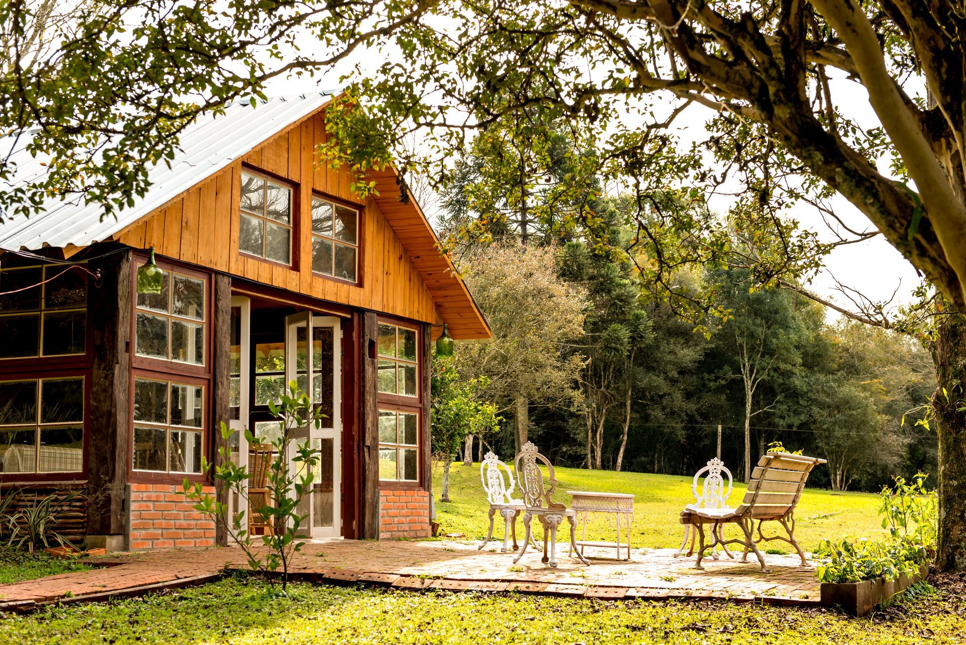a wooden house with a brick walkway leading to it