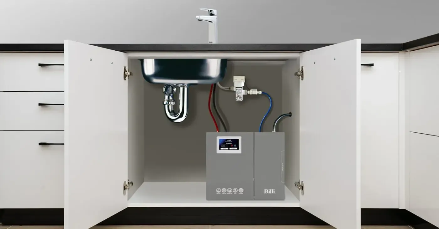 A water filtration system installed under a modern kitchen sink with open cabinet doors.