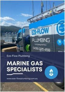 An Eze-Flow Plumbing truck parked by a harbor, featuring the company logo, contact number, and 