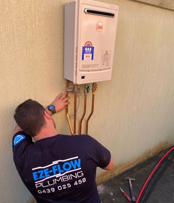Gas fitter installing gas appliance