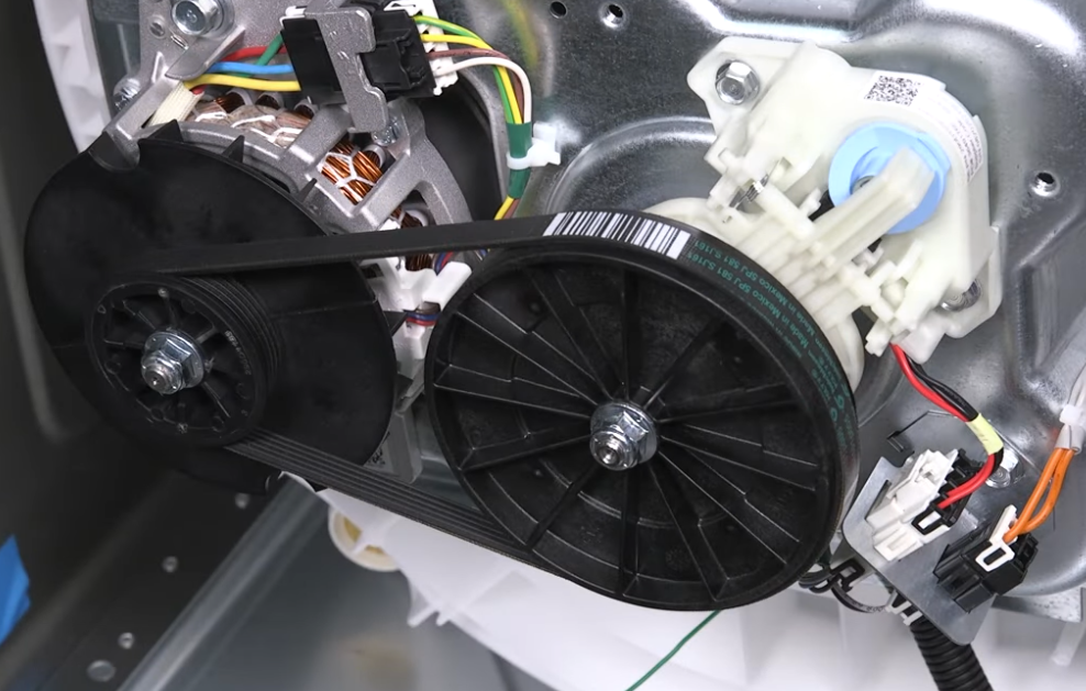 Washing machine interior: motor, belt, and pulleys connected, blue and white components visible.
