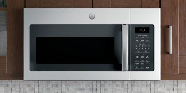 A stainless steel microwave is sitting on a counter