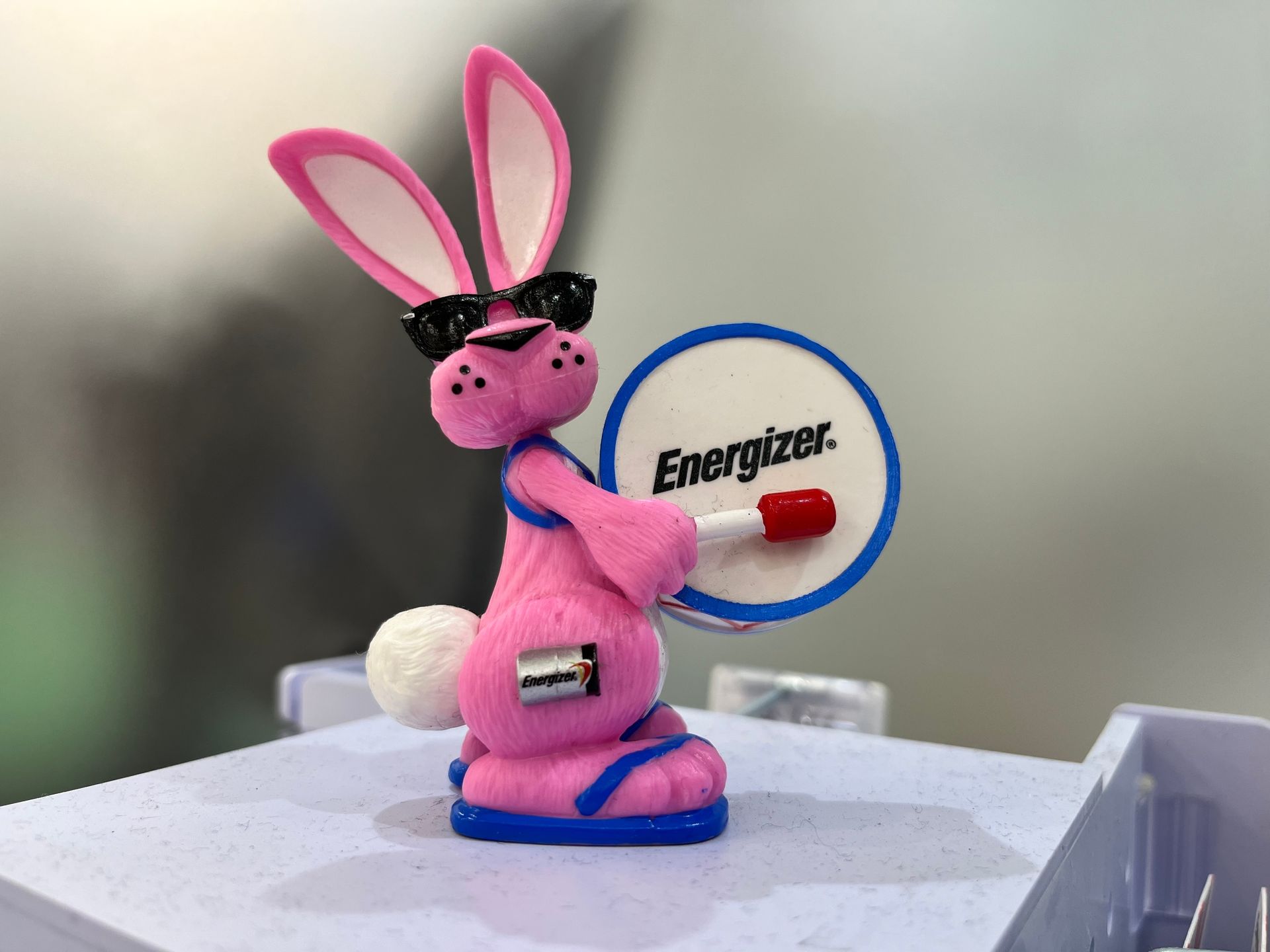 A pink bunny holding a sign that says energizer