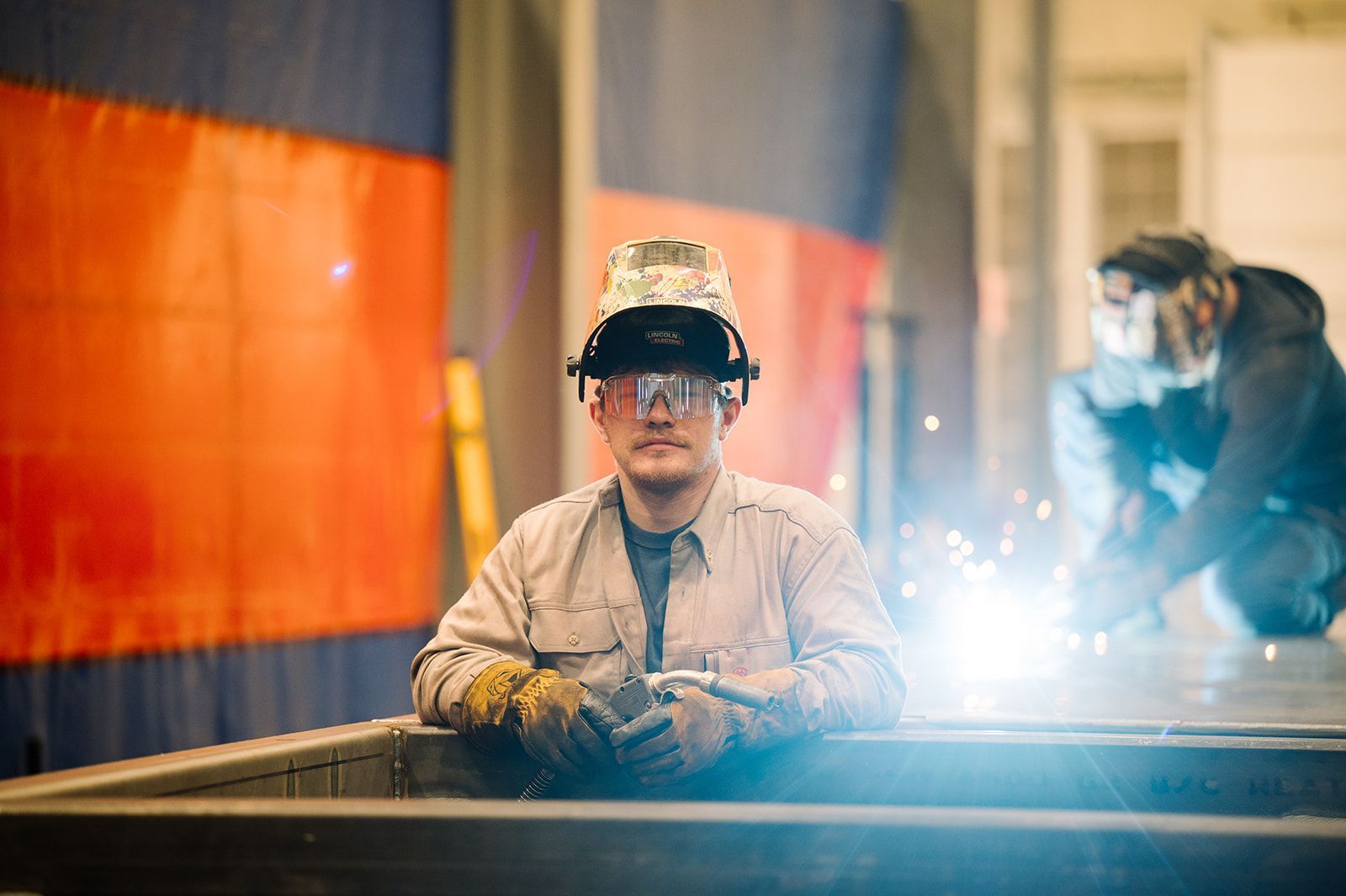 Welder in proper Personal Protective Equipment (PPE).