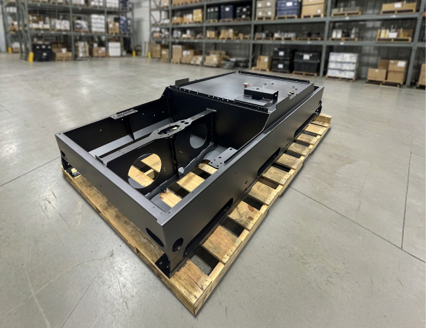 Detailed view of a complex machine weldment featuring machined mounting pads and structural support beams.