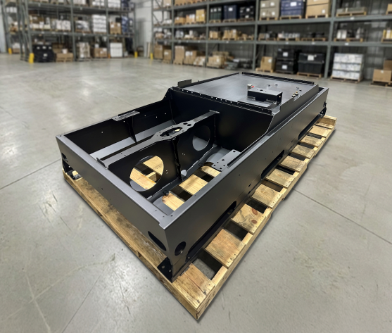 Industrial chassis sub-assembly showing a robust black powder-coated finish and laser-cut hardware slots.