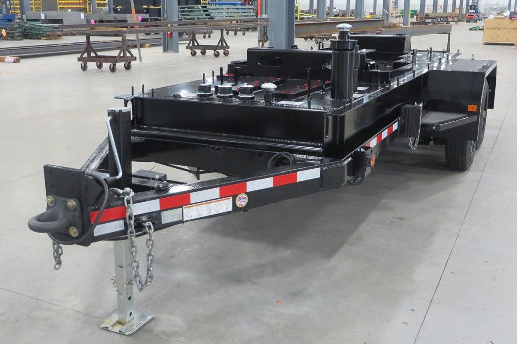 Single-axle heavy-duty trailer with black powder coating and red/white reflective tape.