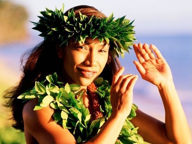 A woman wearing a lei and a wreath on her head