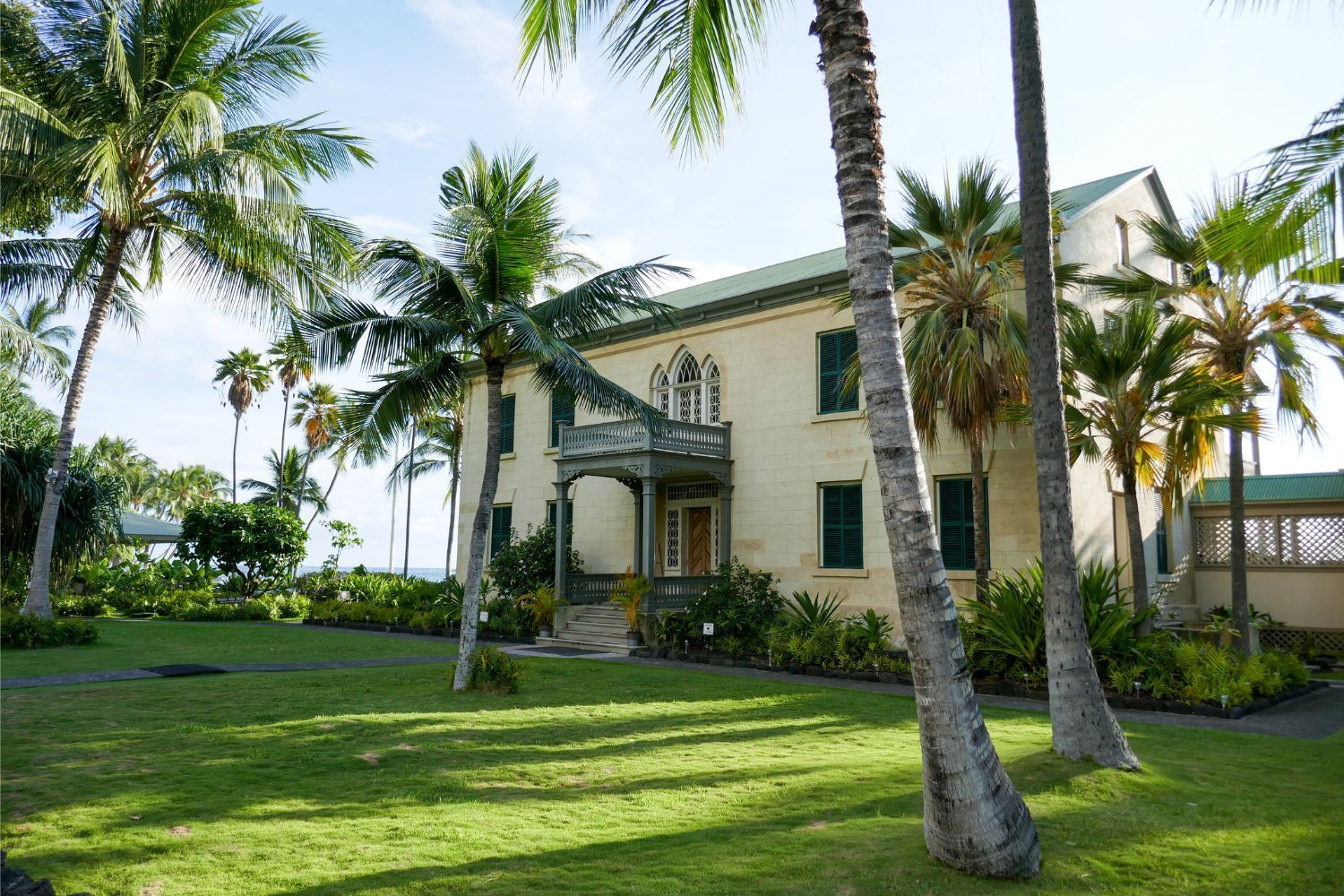 A large house with palm trees in front of it
