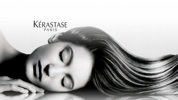 Woman with long, flowing hair; eyes closed. Kerastase Paris logo in top left.