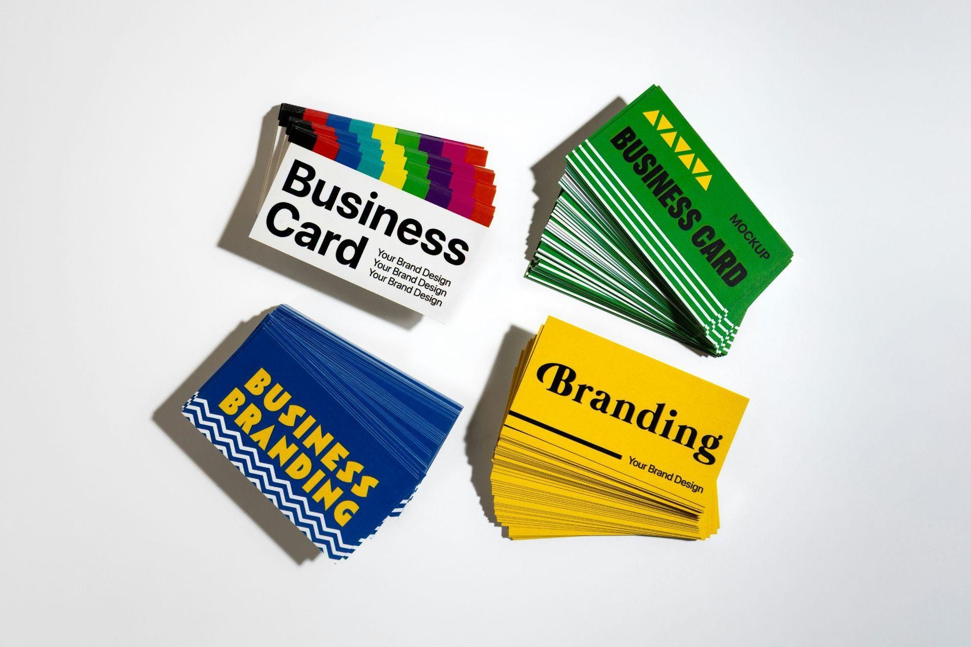Four stacks of colorful business cards with labels like “Business Card” and “Branding” on a white background
