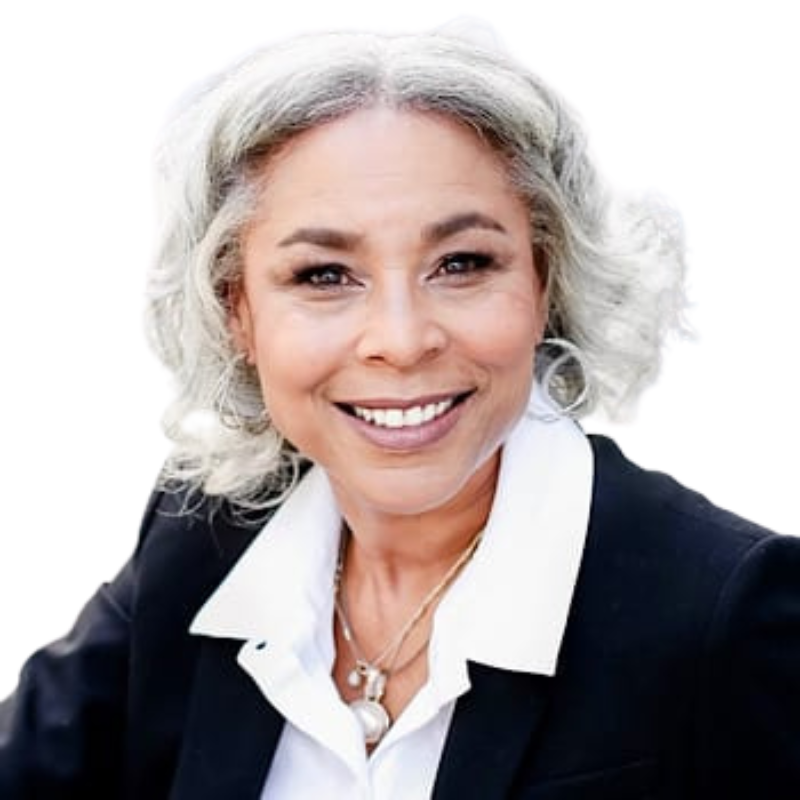 Smiling woman in a black blazer and white shirt against a white background