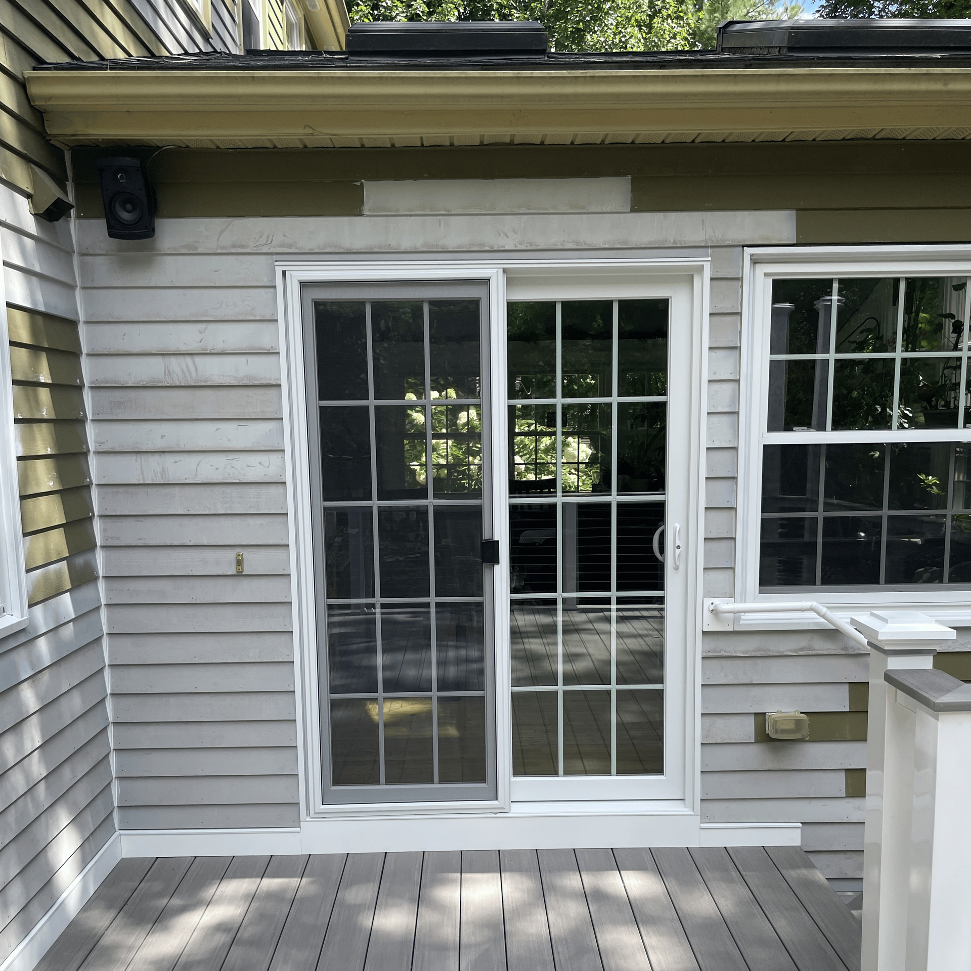 A house with a sliding glass door and a window