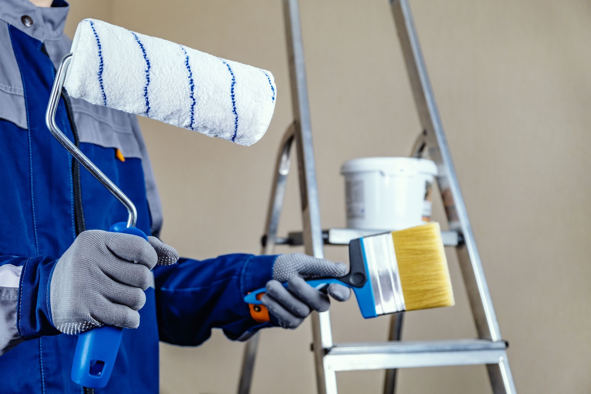 A person is working on a boiler with gloves on.