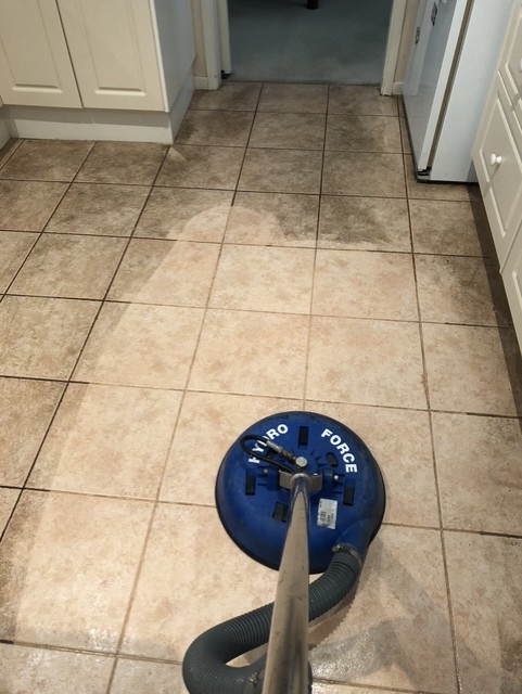Grout cleaning in progress showing the clean and dirty sections side by side