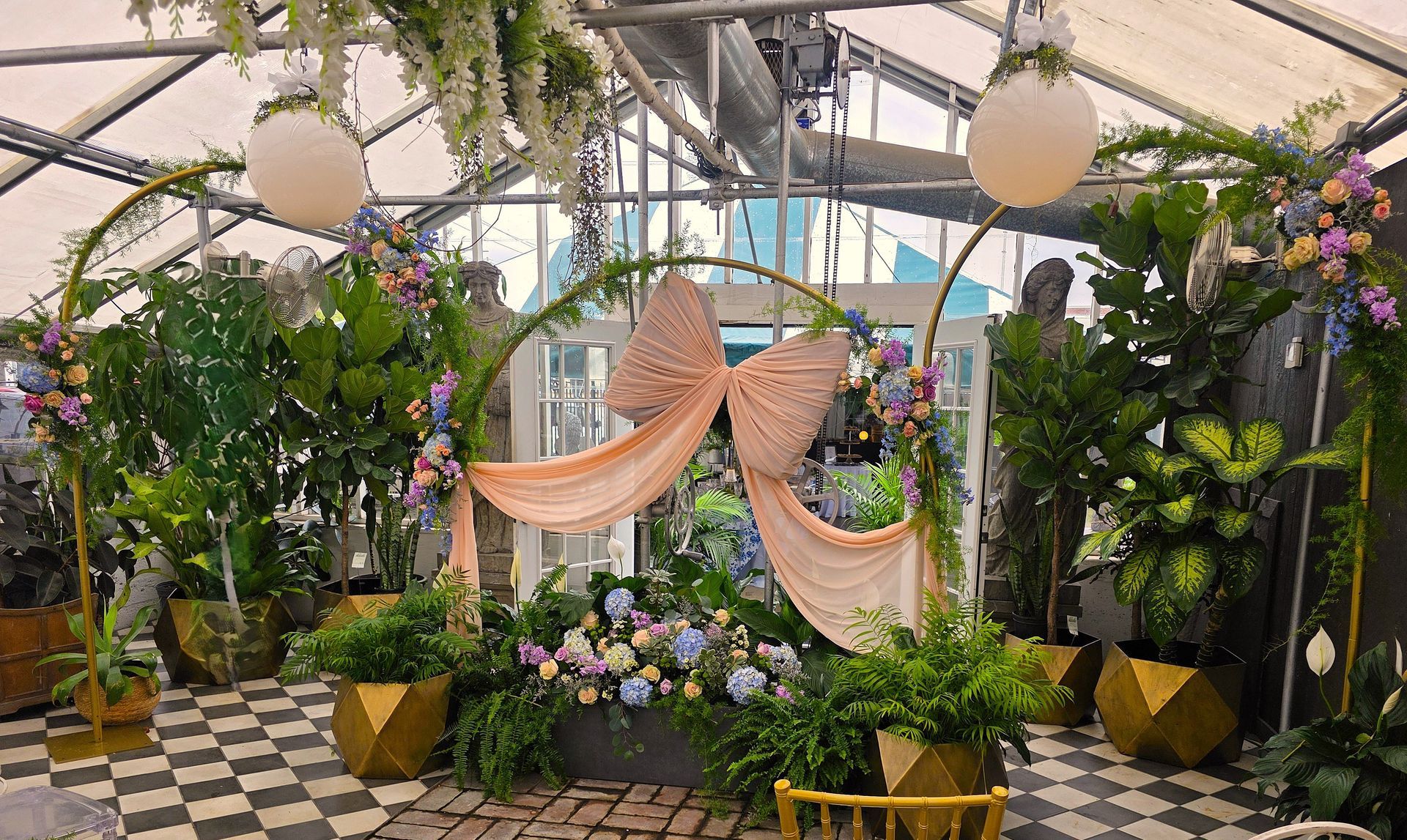 A greenhouse filled with lots of plants and flowers.