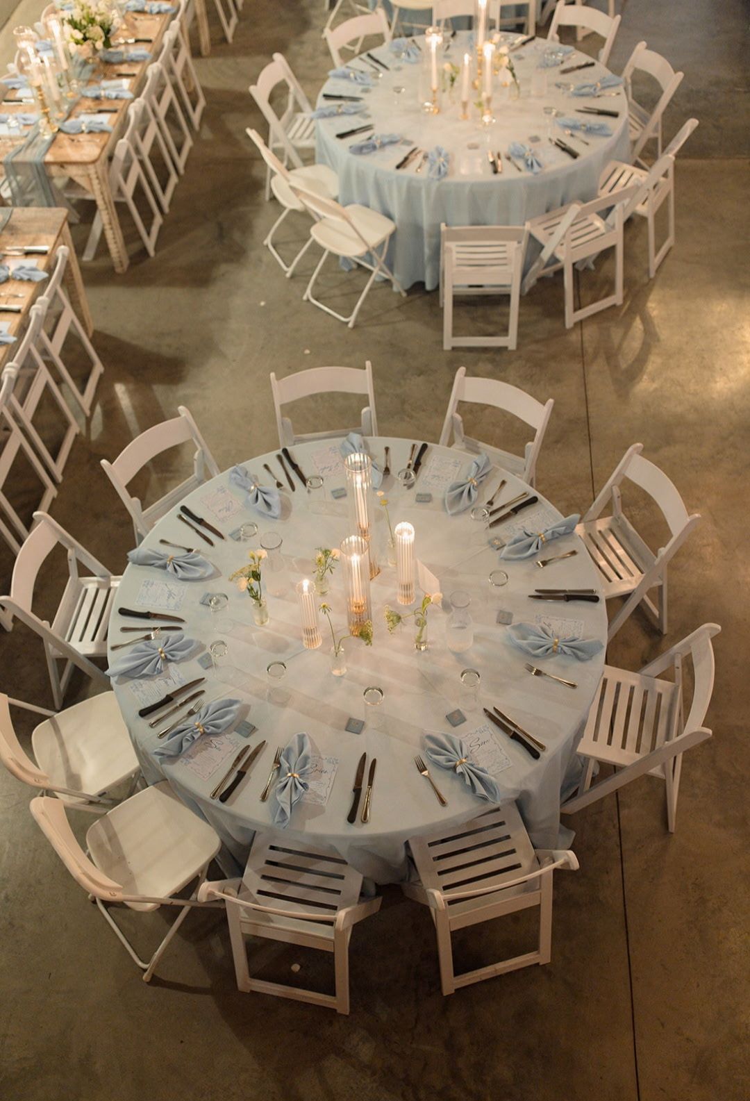 An aerial view of a wedding reception with tables and chairs set up