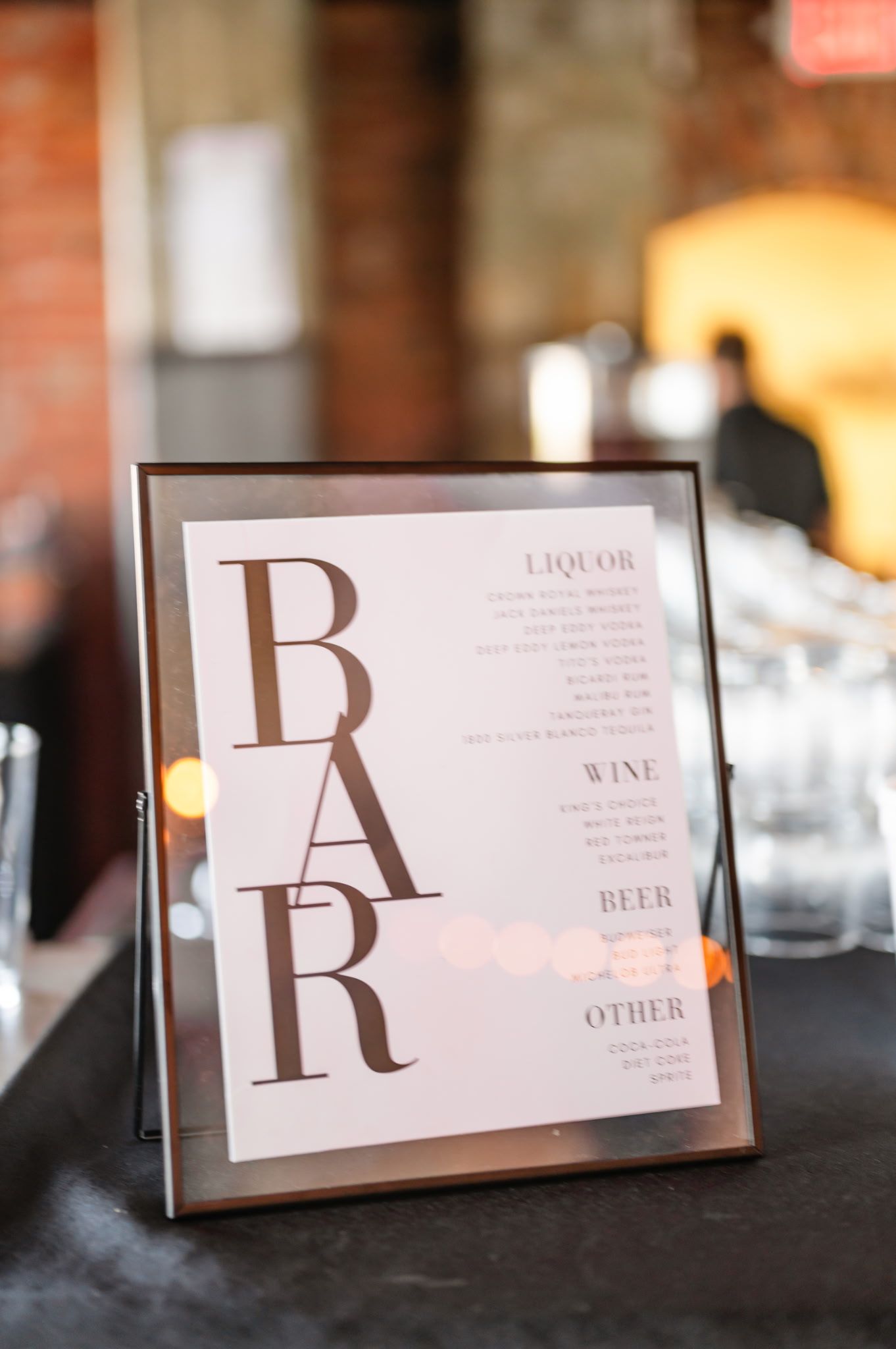 A sign that says bar is sitting on a table.