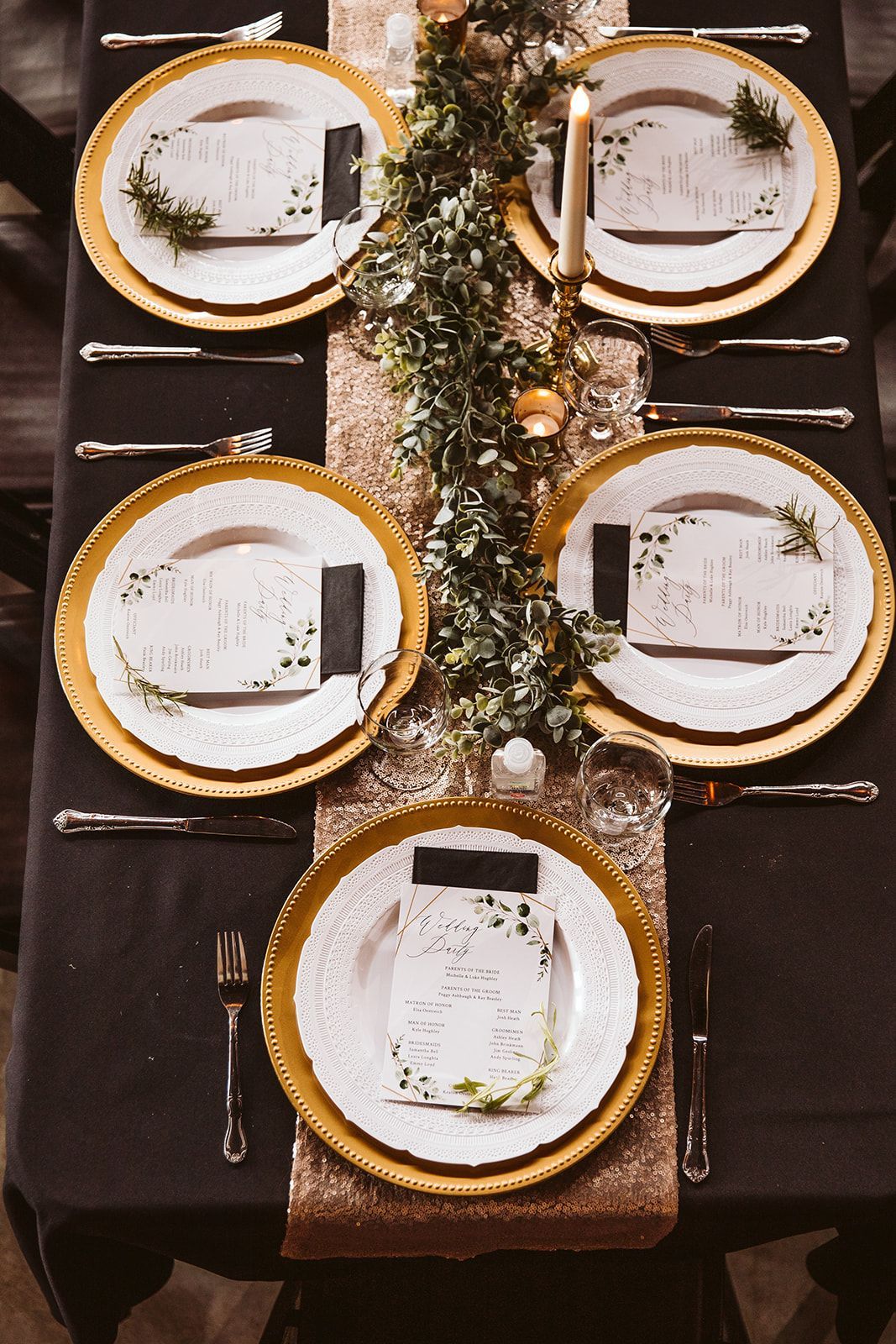 A table with four plates and silverware on it.
