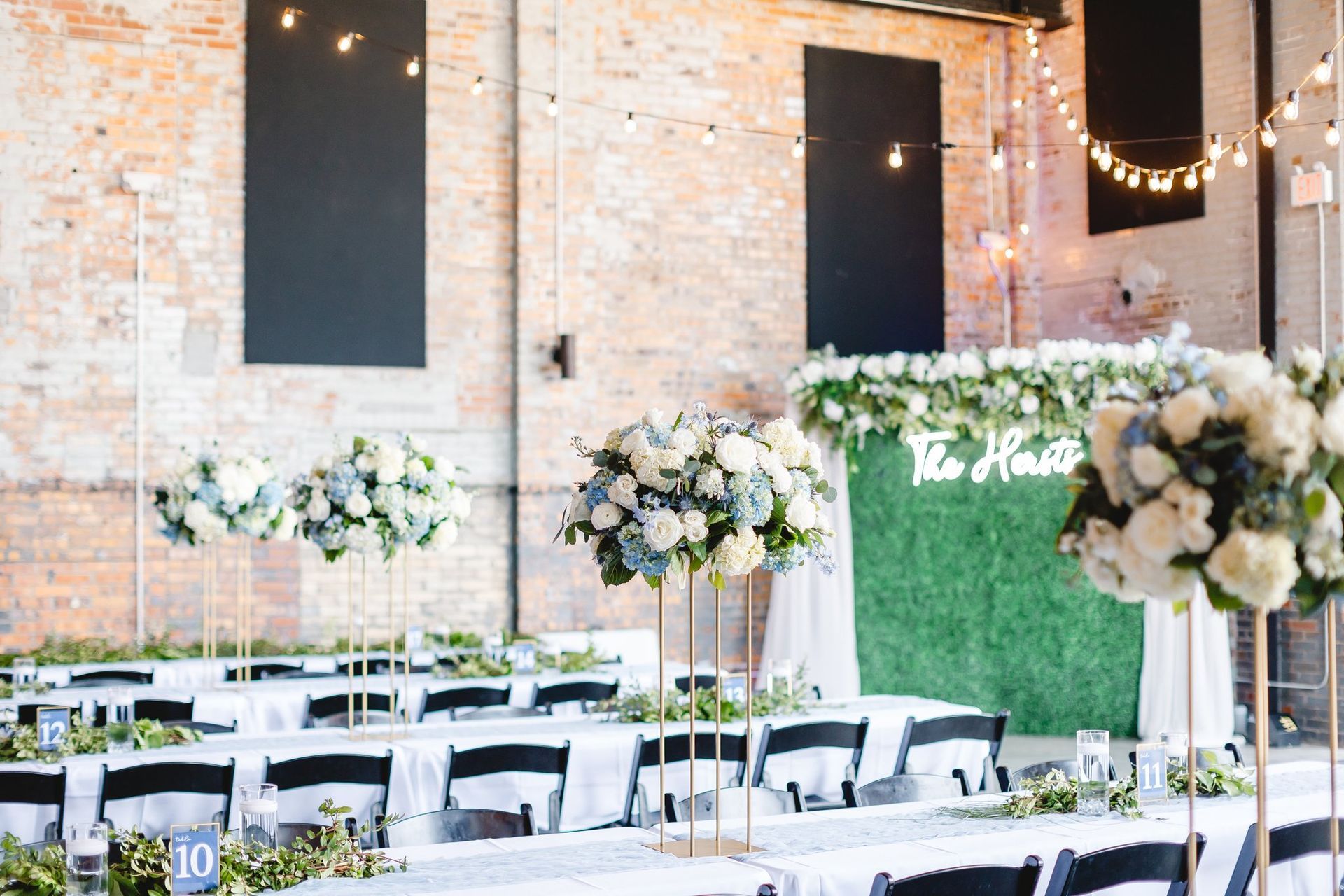 A large room with tables and chairs set up for a wedding reception.