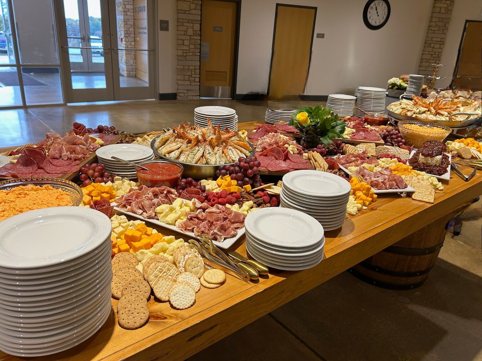 A wooden table topped with plates and plates of food.