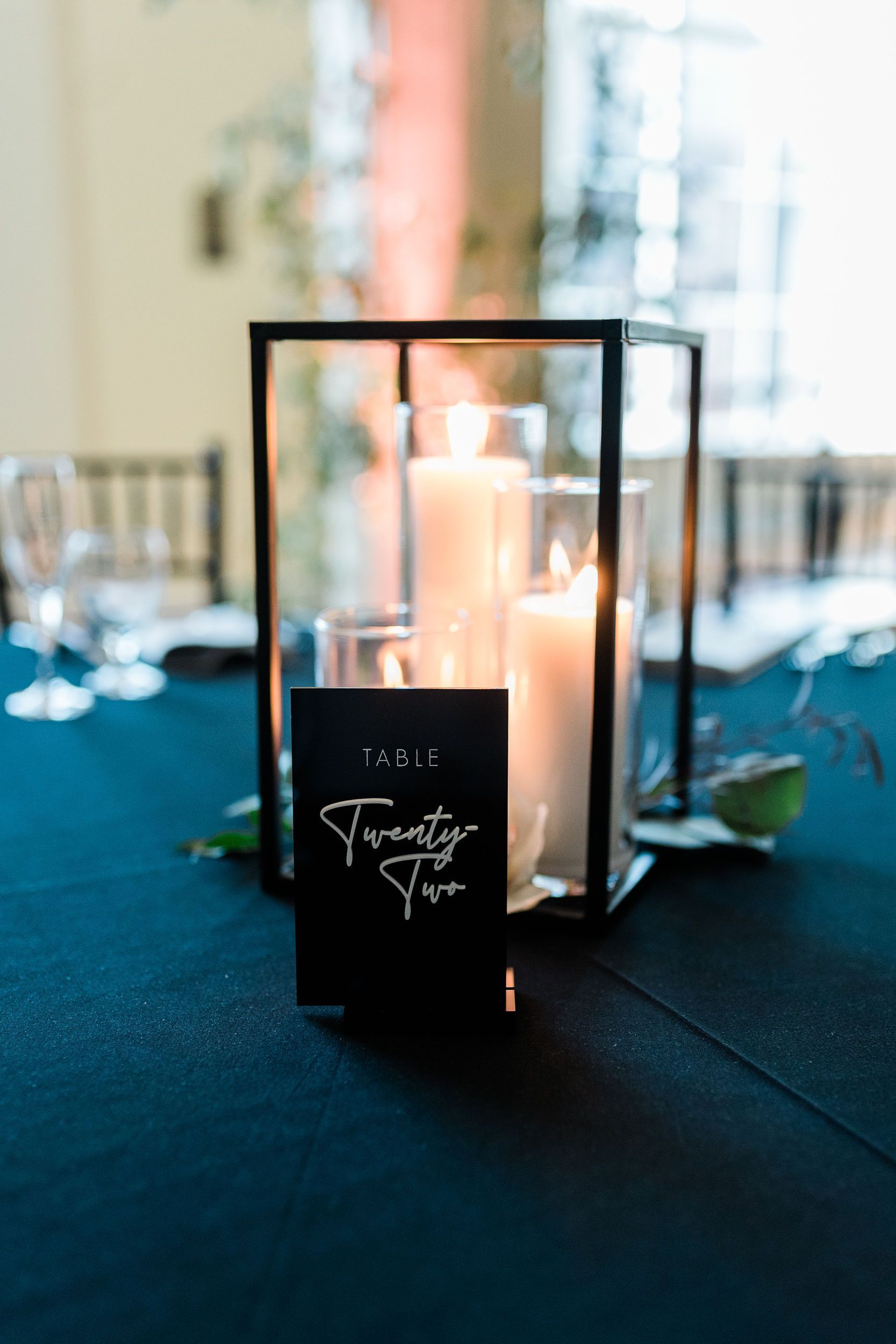A table with a lantern and candles on it.