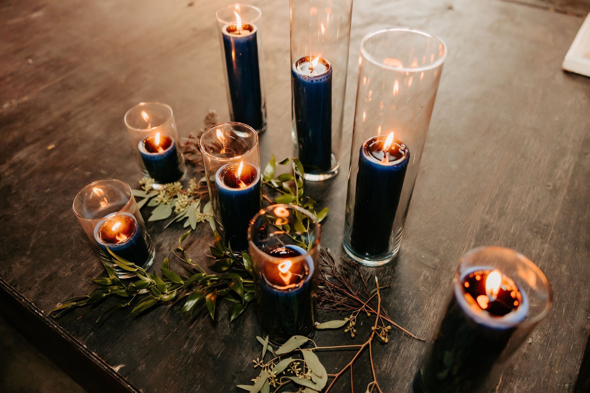 A bunch of candles are sitting on a table.