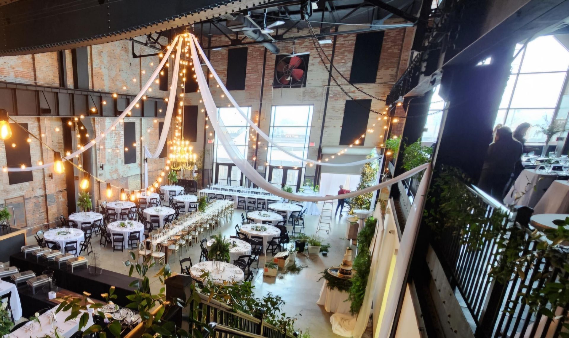 An aerial view of a large room filled with tables and chairs.