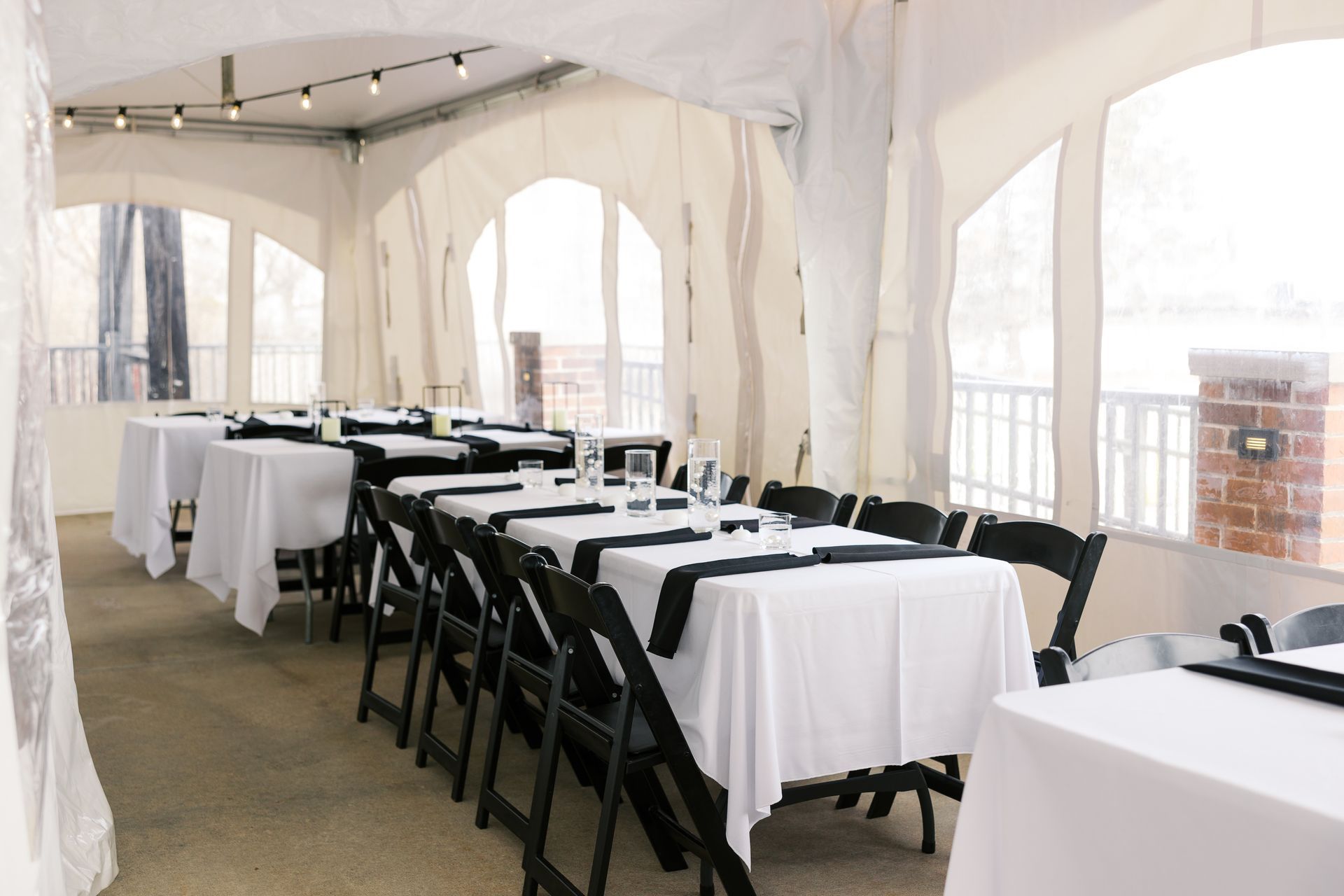 A room with tables and chairs set up under a tent
