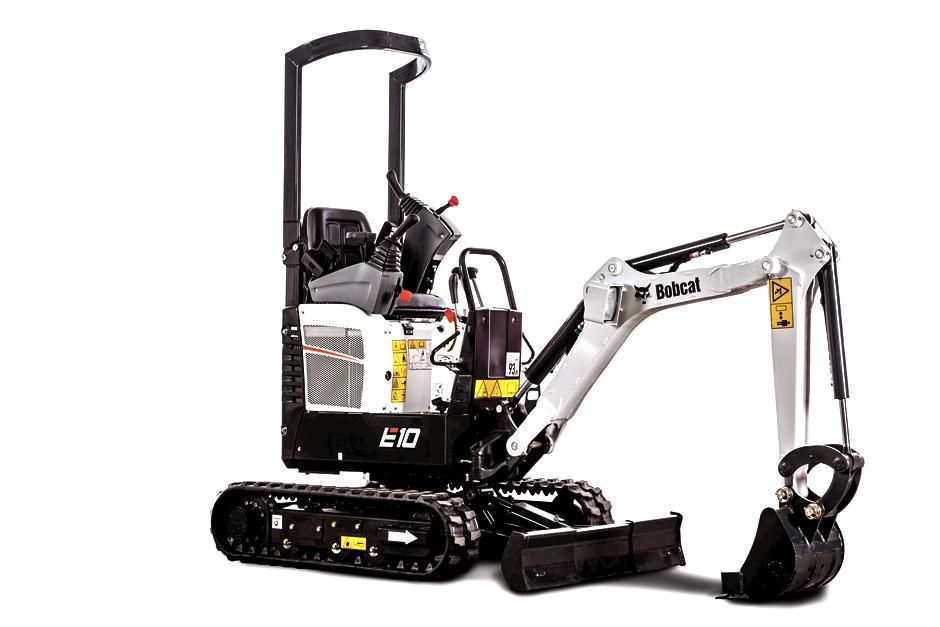 A small excavator is sitting on a white surface.