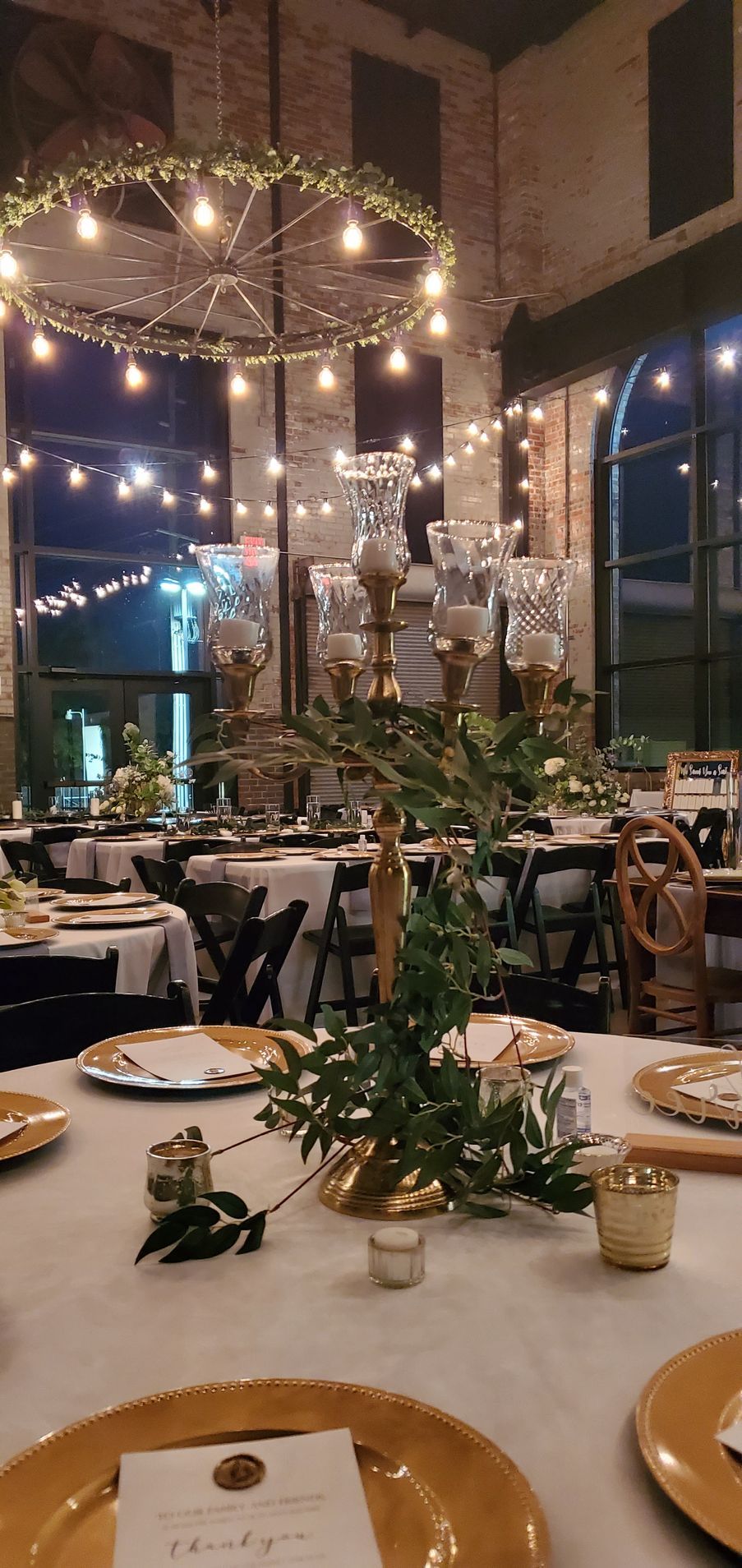 A large room with tables and chairs set up for a wedding reception.
