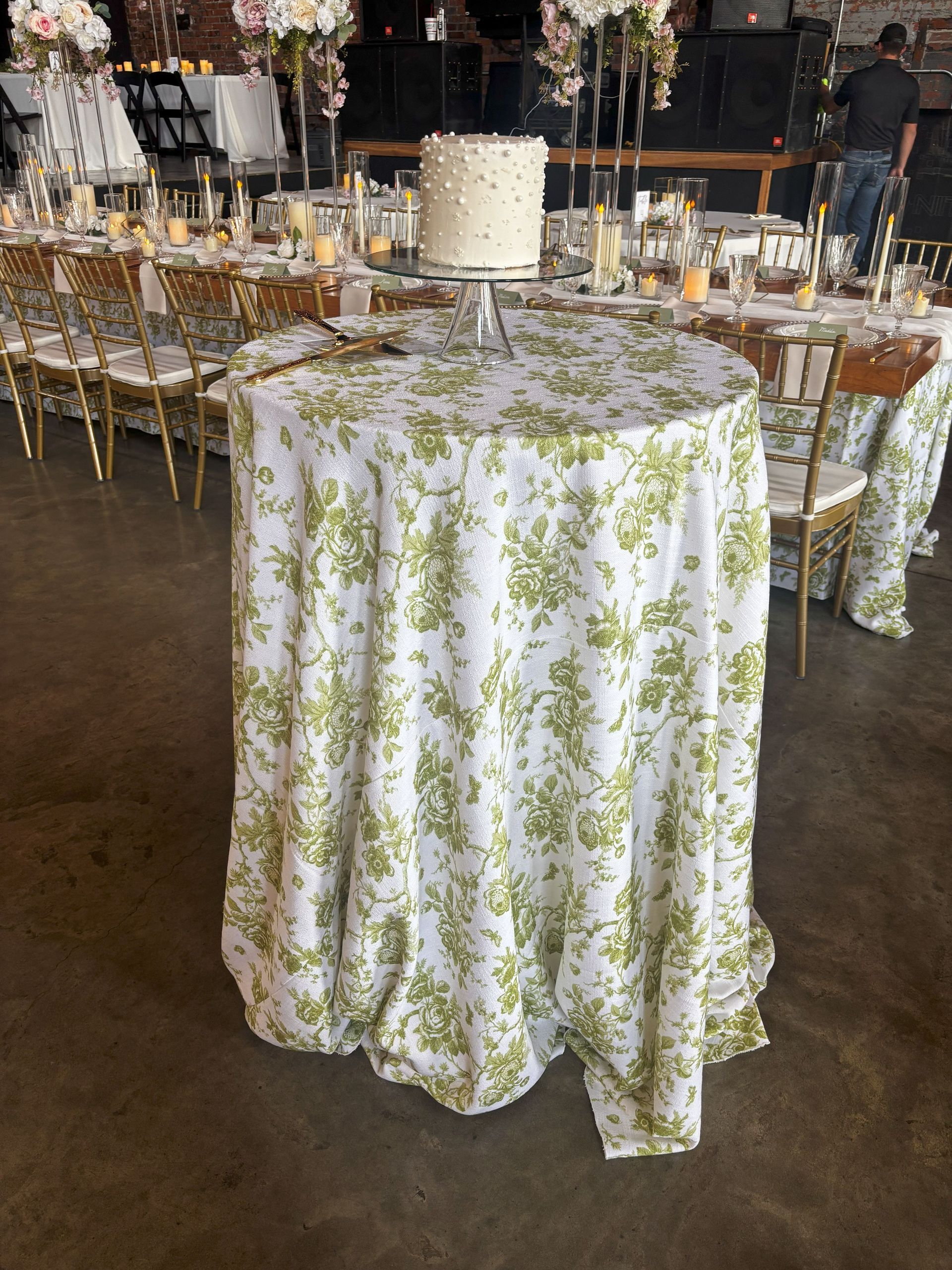 A large room with tables and chairs set up for a wedding reception.