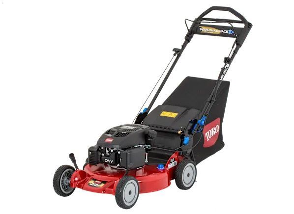 A toro lawn mower is sitting on a white surface.