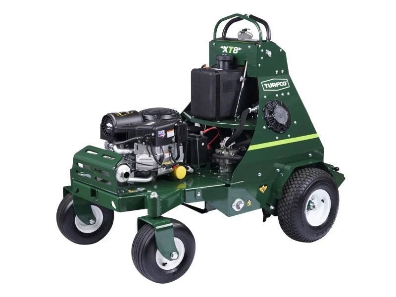 A green lawn mower with white wheels on a white background