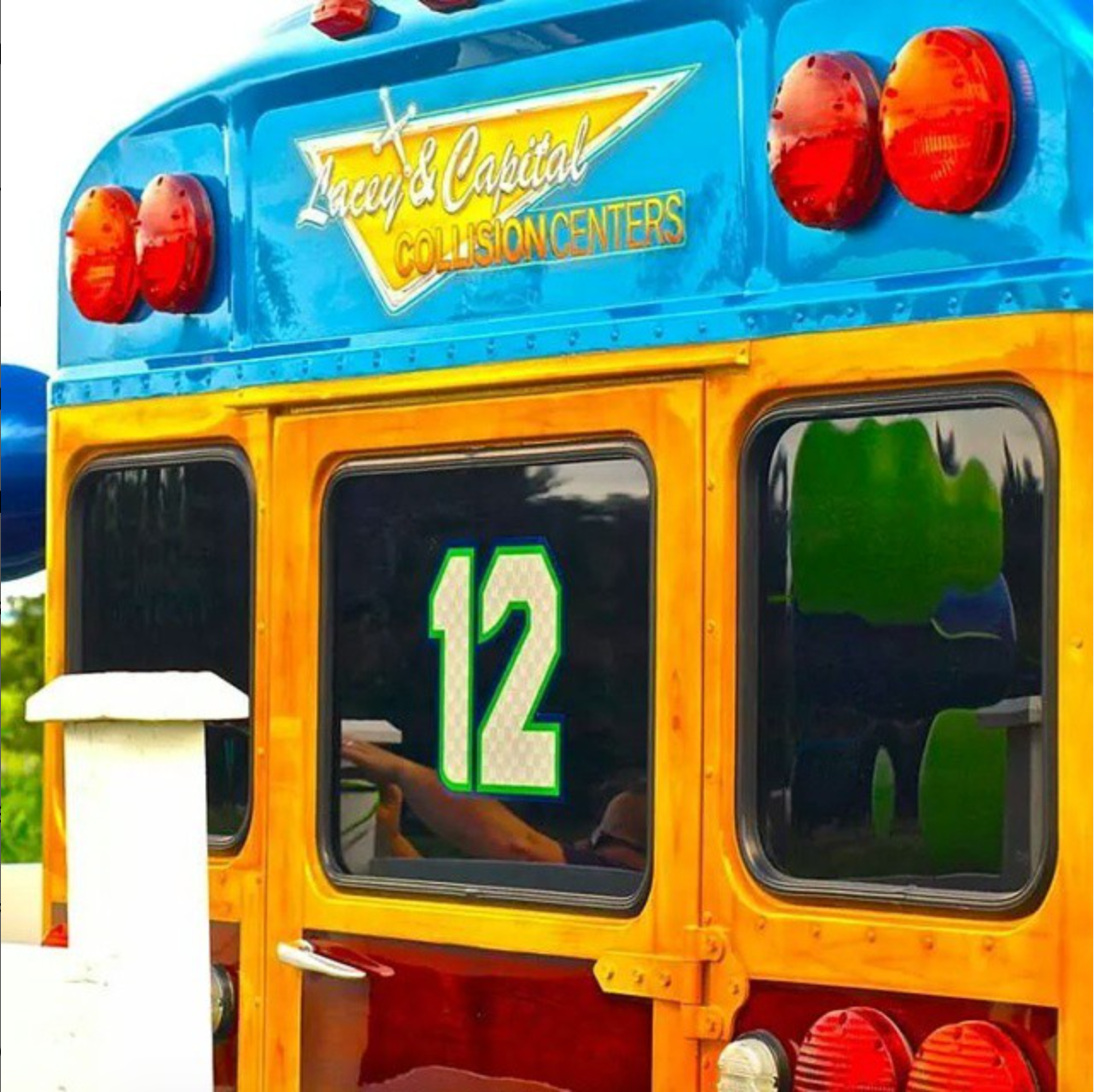 A blue and yellow bus with the number 12 on it