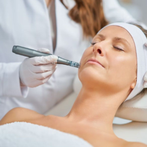 Skincare treatment with a handheld facial device on a woman lying down with eyes closed