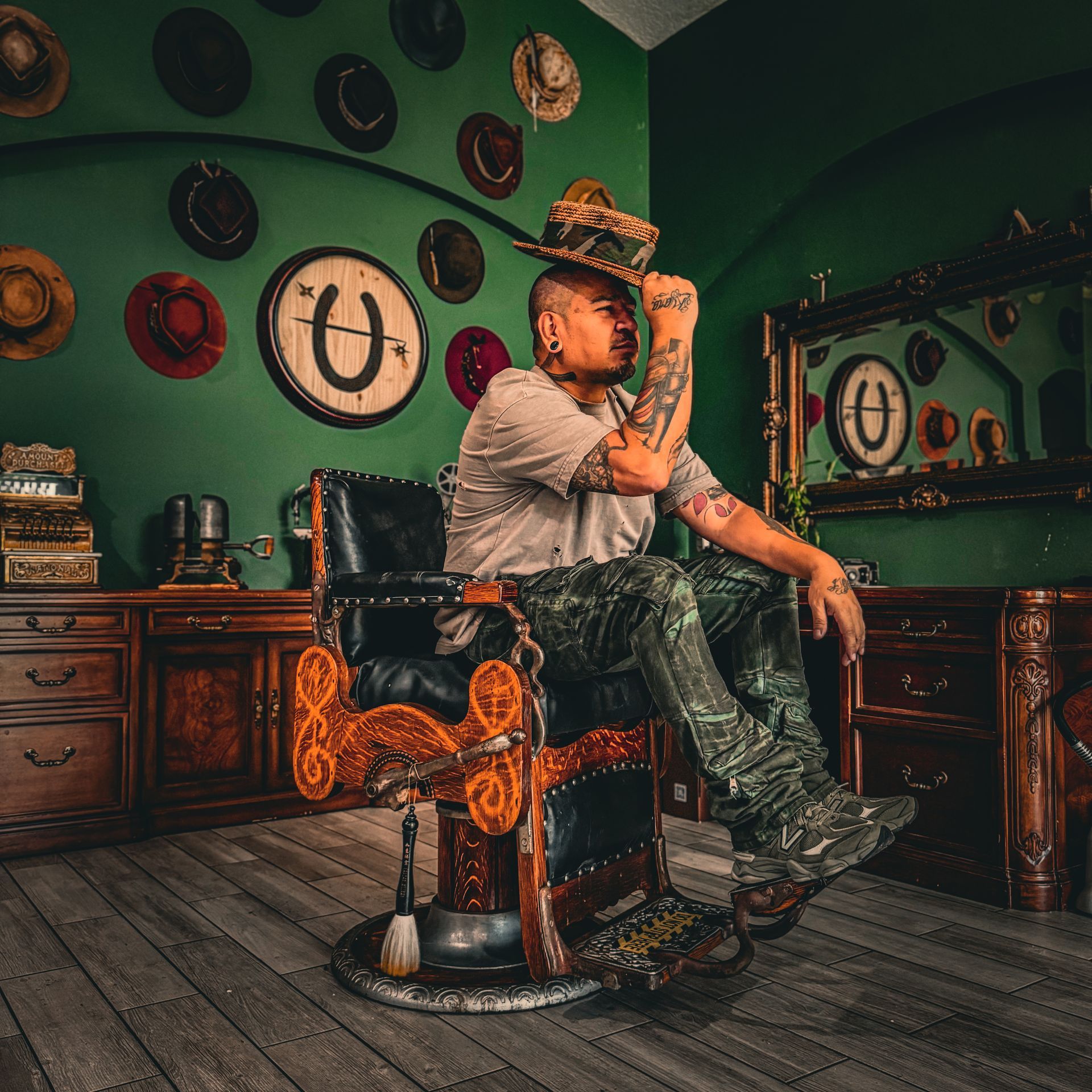 Charlie Lopez, Orlando barber and hatter, seated in an antique barber chair