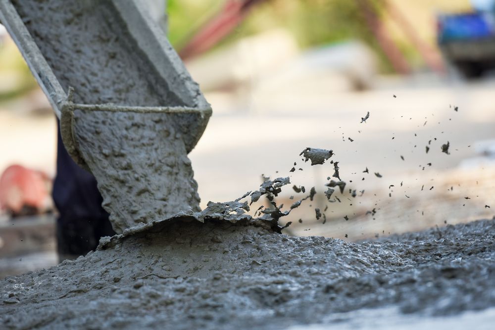 Concrete Pouring From a Chute Onto a Surface — Nambucca Concrete Pumping in Kempsey, NSW