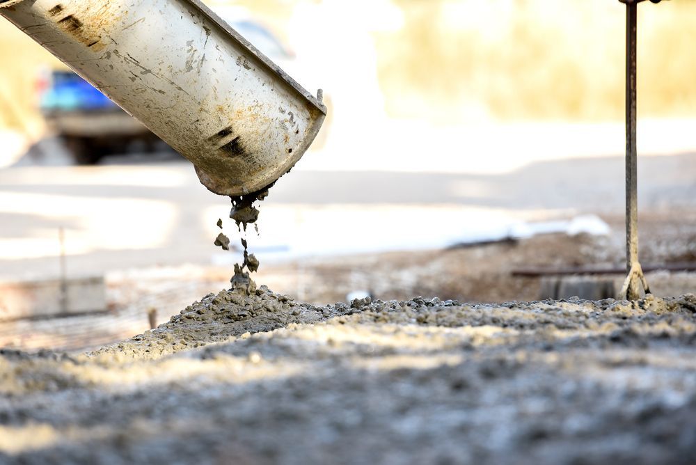 Concrete Being Poured From a Truck Chute Onto a Construction Site — Nambucca Concrete Pumping in Macksville, NSW