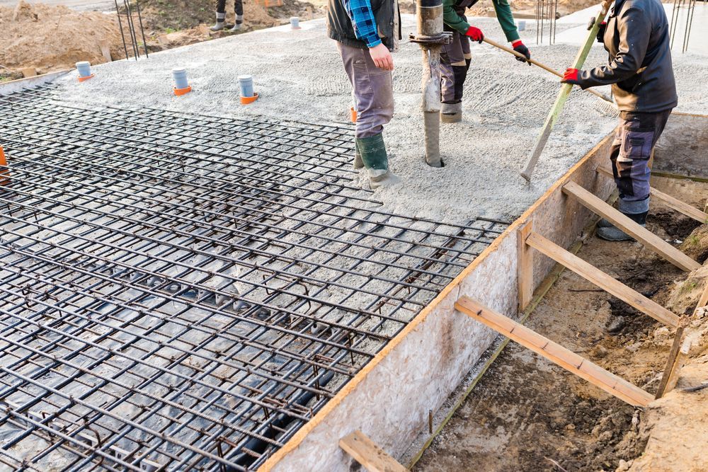 Construction Workers Pouring Concrete Into a Foundation With Rebar Reinforcement — Nambucca Concrete Pumping in Valla, NSW