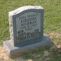 A gray granite headstone inscribed