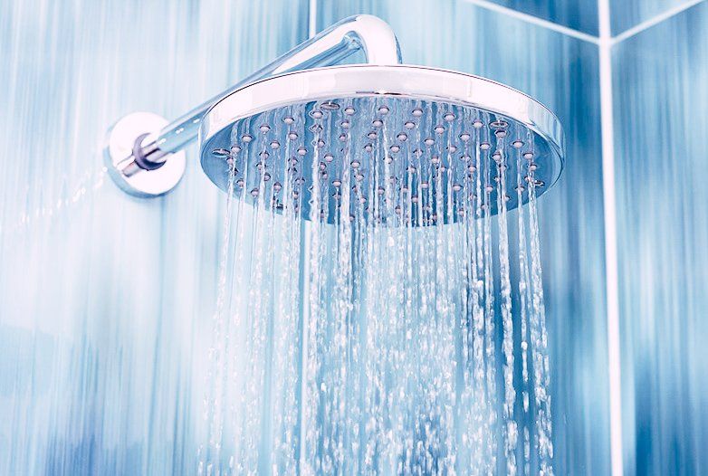 a shower head with hot water coming out of it