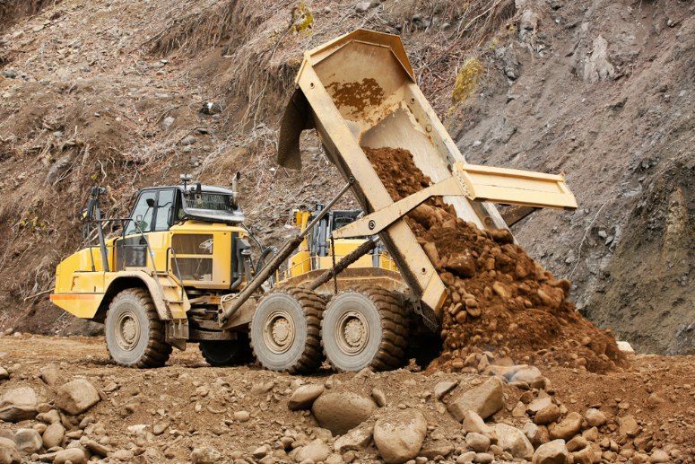 A Dump Truck is Dumping Dirt Into a Pile of Rocks — Bennettron Demex in Port Macquarie, NSW